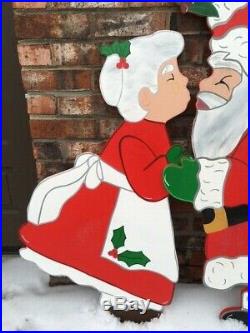 Christmas Santa Claus & Mrs. Claus kissing under the Mistletoe Wood Outdoor Yard