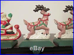 MIDWEST PAINTED CAST IRON SANTA & TWO PINK REINDEER CHRISTMAS STOCKING HOLDERS