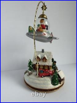 Santa's Fly by Snowglobe by Christopher Radko Christmas Music Box Airplane